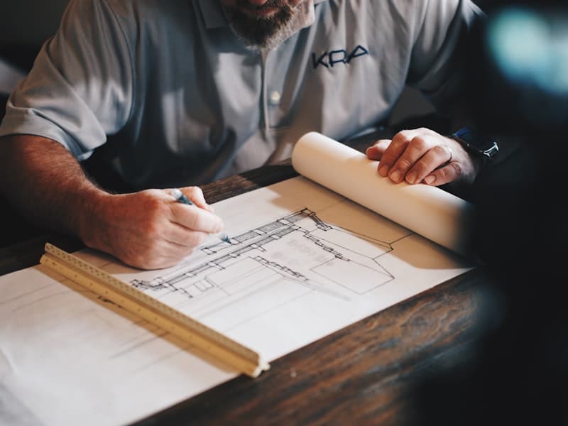 Architect reviewing building plans for MEES compliance